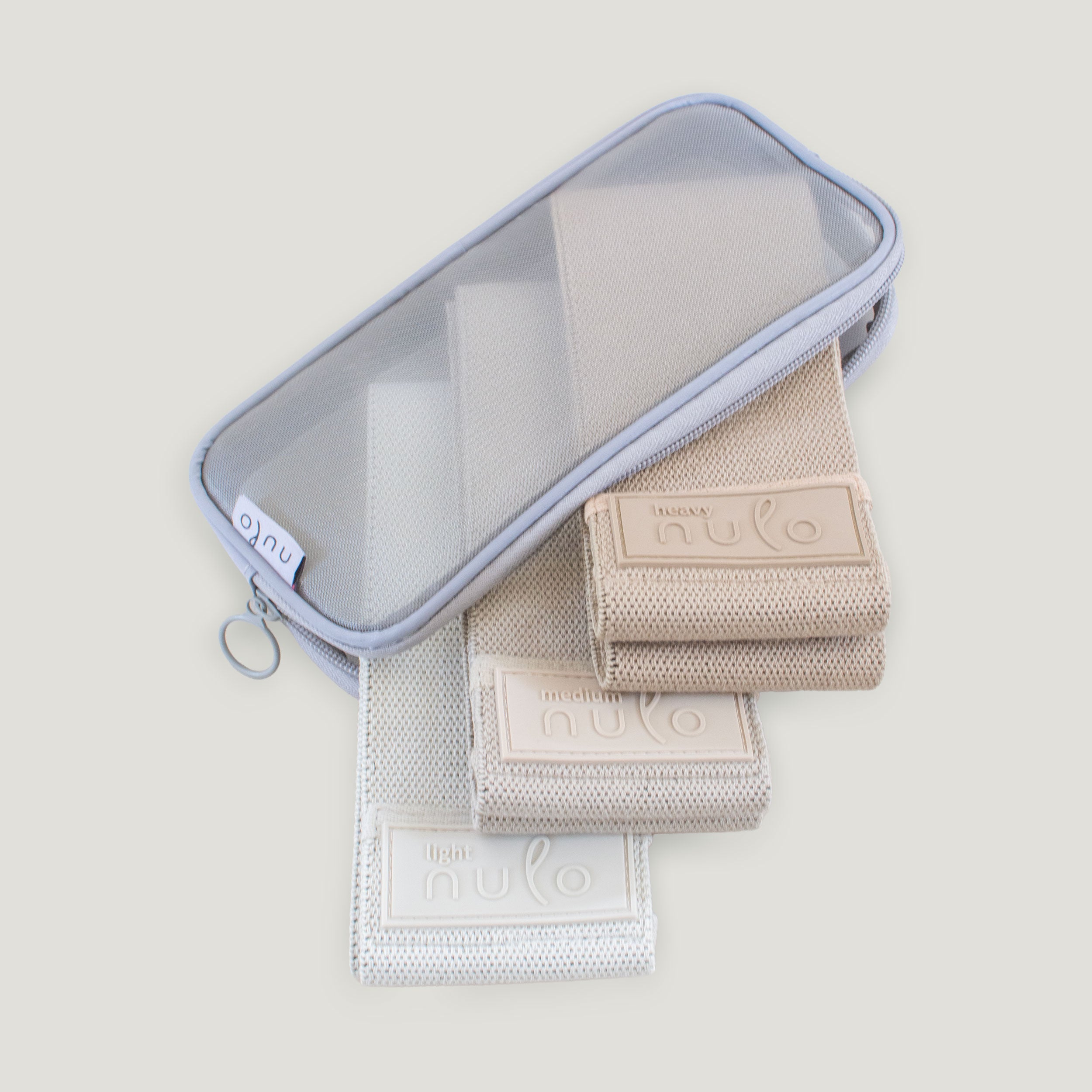 A light lavender mesh zippered pouch with a key ring, shown open with three Fabric Resistance Bands - nulo