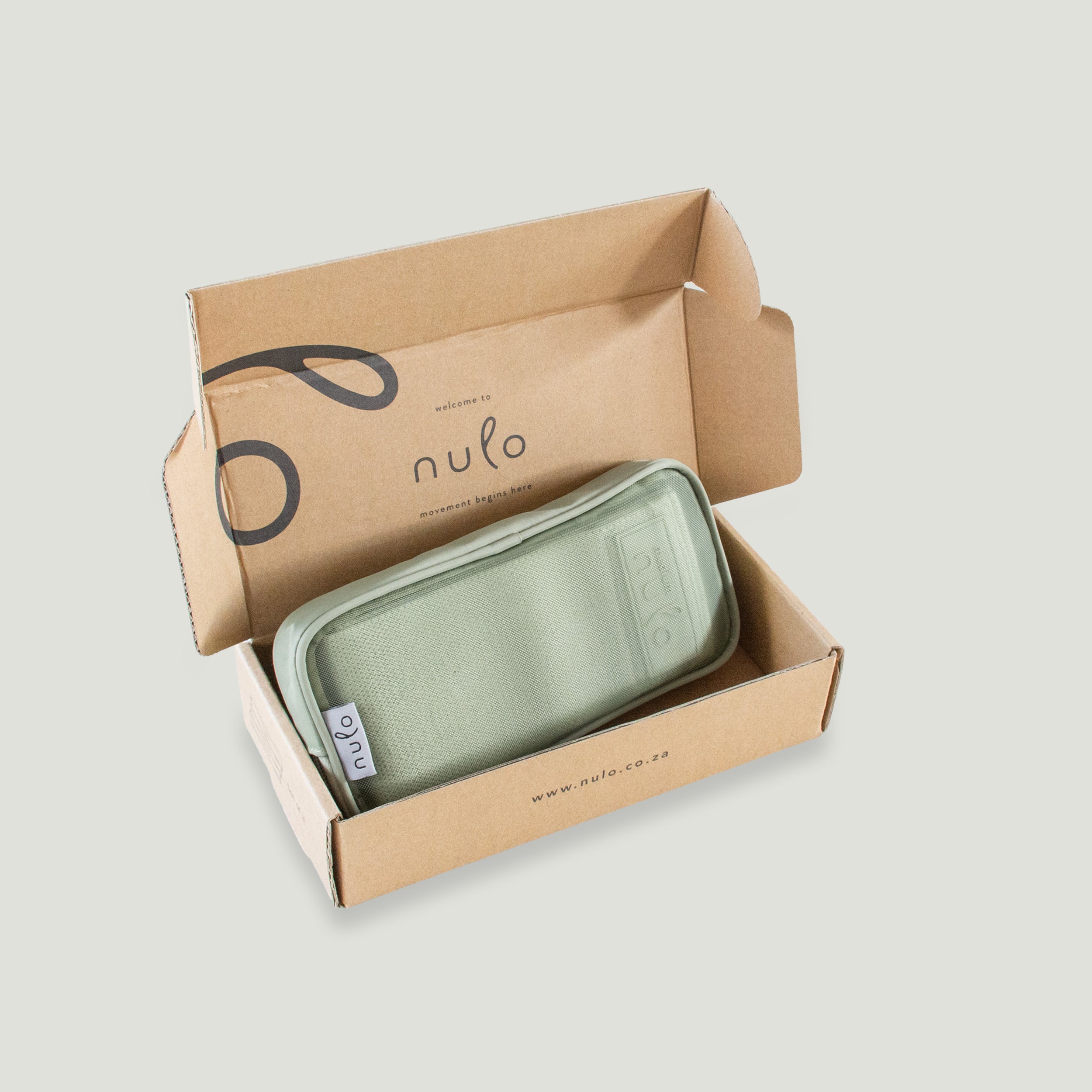 A sage green zippered pouch with a white 'nulo' tag, presented inside an open brown cardboard box branded with 'nulo' on a light gray background.