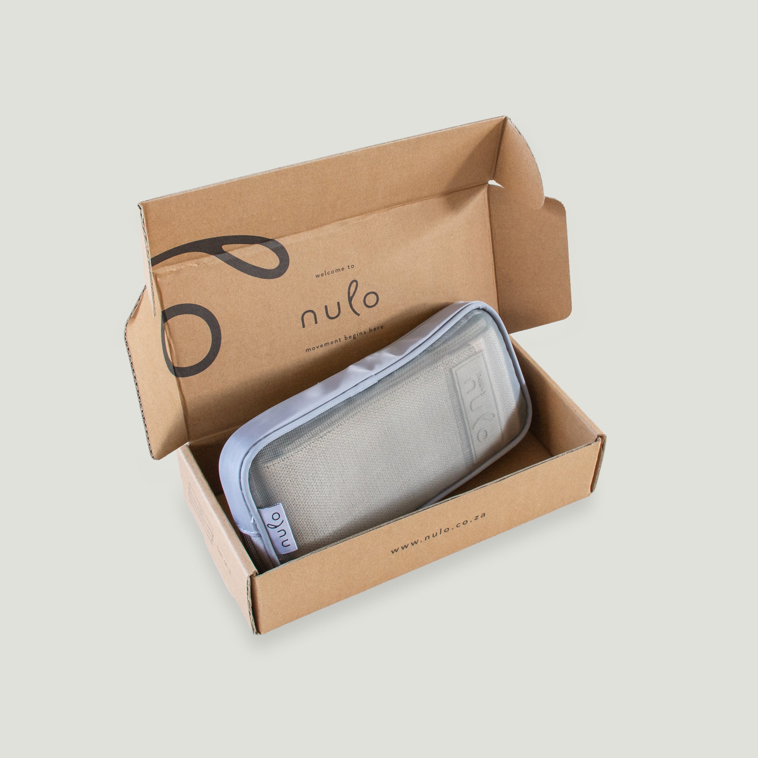 A light gray zippered pouch with a white logo patch, displayed inside an open brown cardboard box printed with the brand name 'nulo'.